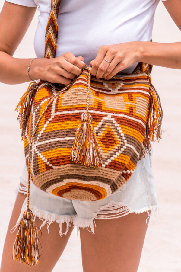 girl in white t-shirt holding Authentic Handmade Wayuu Bag