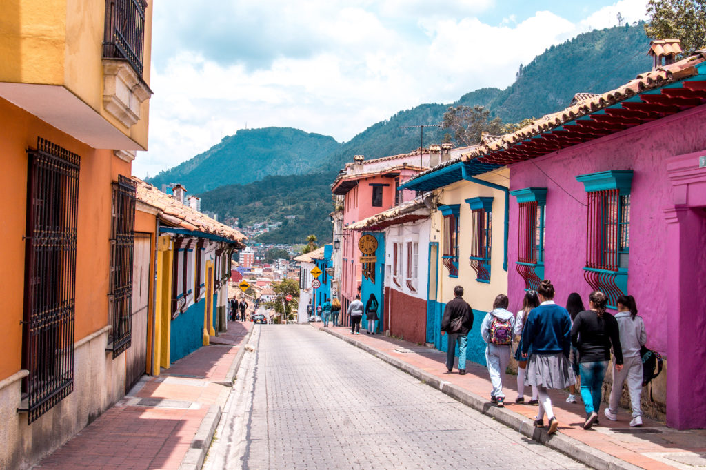 a street with pedestrians and colorful houses in Candelaria, Bogota still you might wonder is south america safe