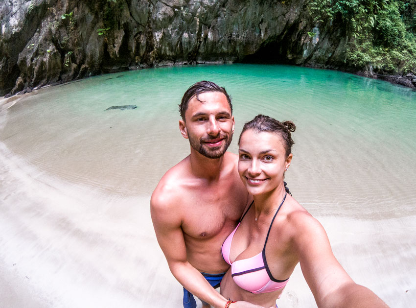 two people in emerald cave surrounded with blue water and rocks
one of the many beautiful experiences in Thailand