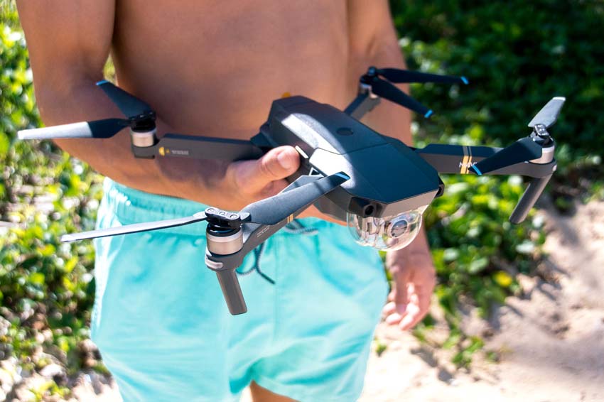 a boy presenting a drone a travel must have 