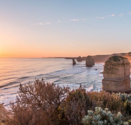 sunset photo at Twelve Apostles, pinky sky, rocks and ocean which is must see during Great ocean road itinerary in 2 days