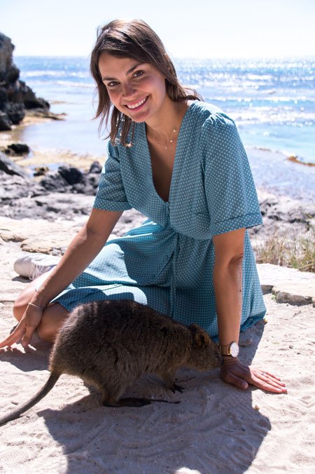 woman sitting on the ground on Rottnest Island with quokka