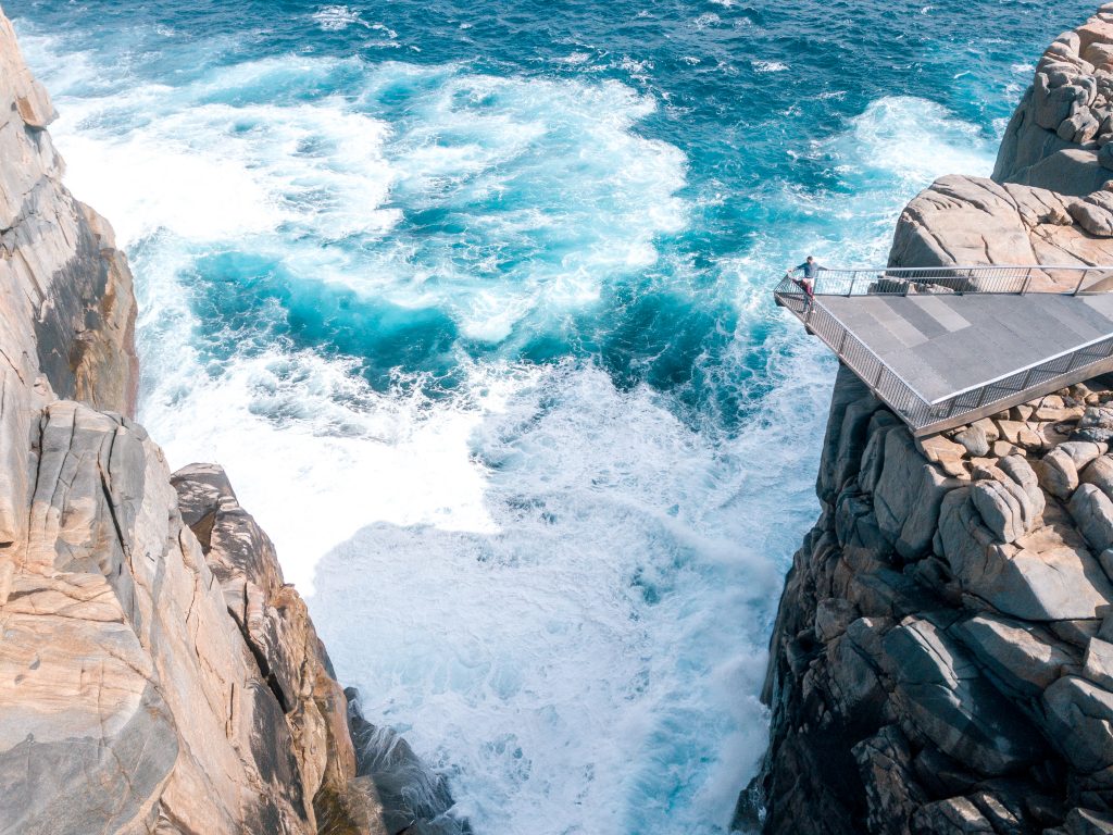 Aerial view on a viewing platform that hangs over a cleft at the ocean cliffs