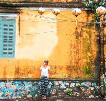 best things to do in Hoi An, Vietnam, yellow wall, blue window and a girl standing